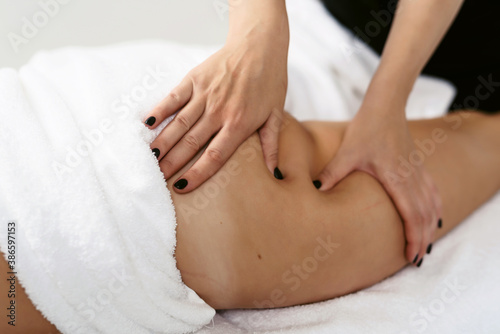 Fat burning massage. masseur making anti cellulite massage for young woman in wellness center or beauty salon. Perfect skin beauty concept