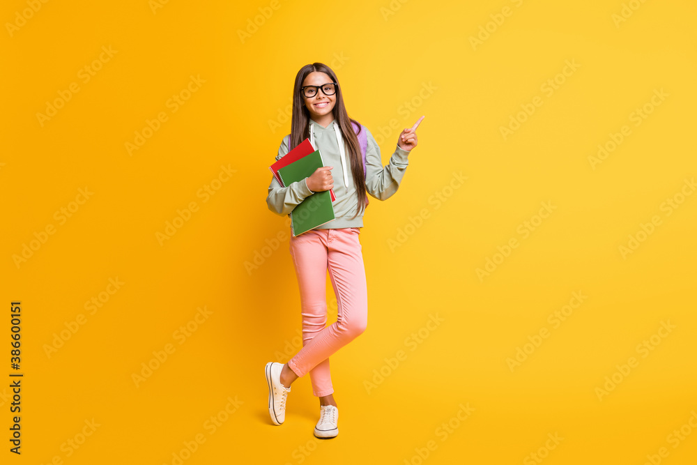 Full size photo of beautiful brunette student hold book bag go back learn trendy isolated on yellow color background Full size photo of beautiful brunette student hold book bag go back learn trendy isolated on yellow color background
