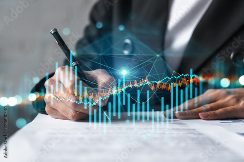Woman signs agreement. Forex financil market chart and graph hologram. Double exposure . Brokerage concept. photo