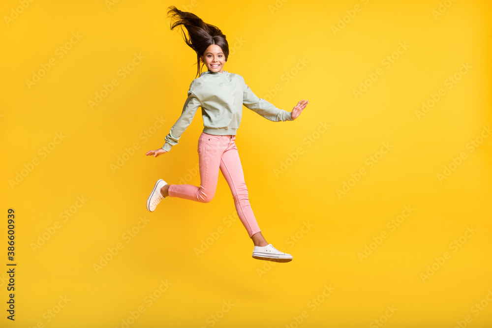Full body portrait of school person jumping hair fly happiness isolated on bright yellow color background
