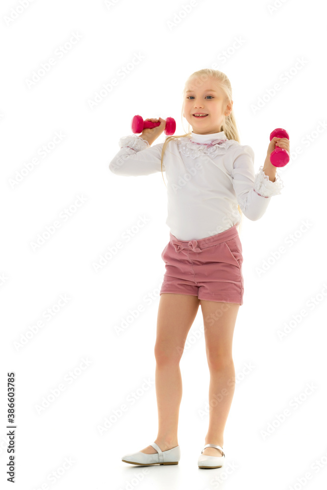 Little girl doing exercises with dumbbells. Little girl doing exercises with dumbbells.
