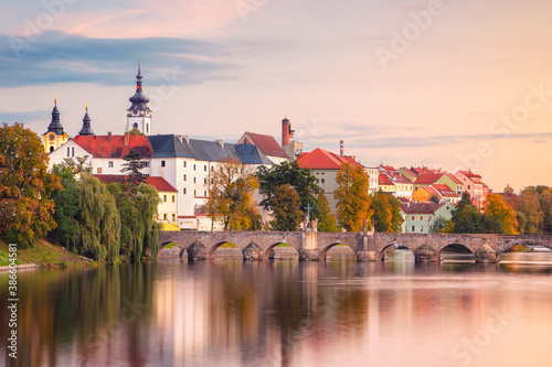 Pisek, Czech Republic. Cityscape image of Pisek with famous Stone Bridge at beautiful autumn sunset.
