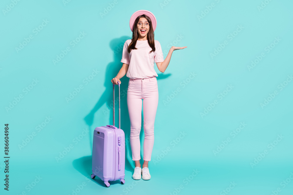 Full length body size view of her she nice attractive pretty slim cheerful amazed girl holding bag copy space on palm isolated bright vivid shine vibrant green turquoise color background Full length body size view of her she nice attractive pretty slim cheerful amazed girl holding bag copy space on palm isolated bright vivid shine vibrant green turquoise color background
