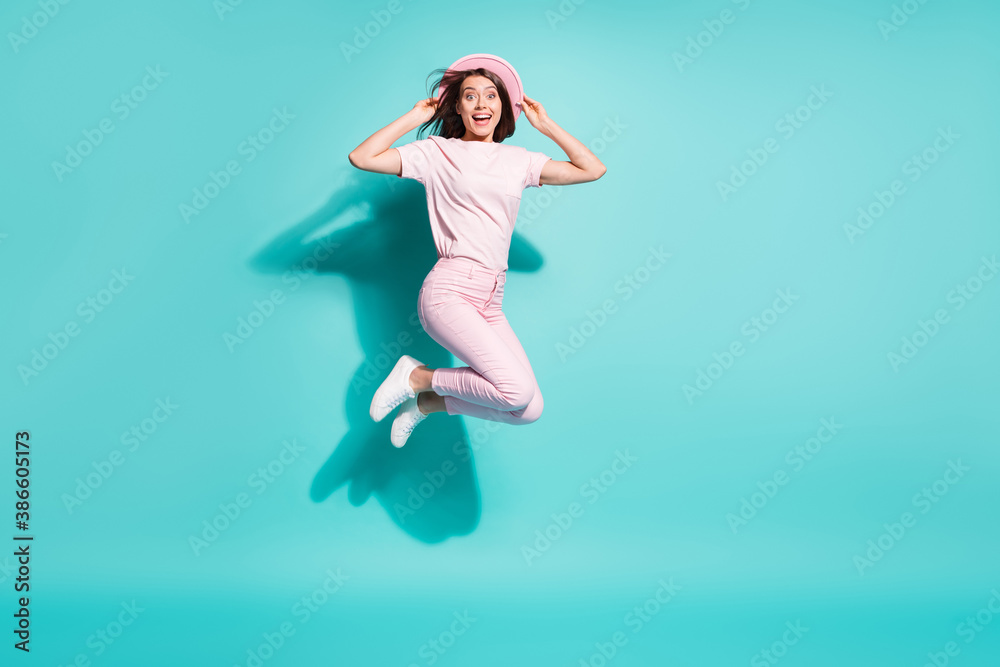 Full length body size view of her she nice attractive pretty cheerful glad amazed girl jumping having fun touching cap good mood isolated bright vivid shine vibrant green turquoise color background