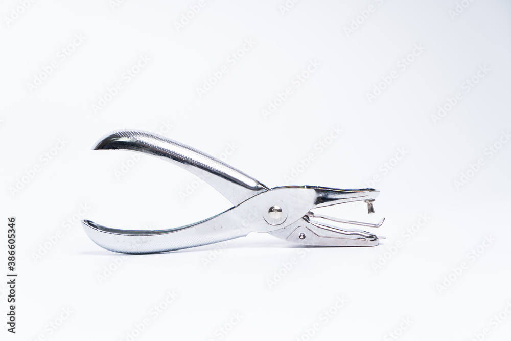 Metal Paper Hole Puncher Isolated on White Background. Metal Paper Hole Puncher Isolated on White Background.