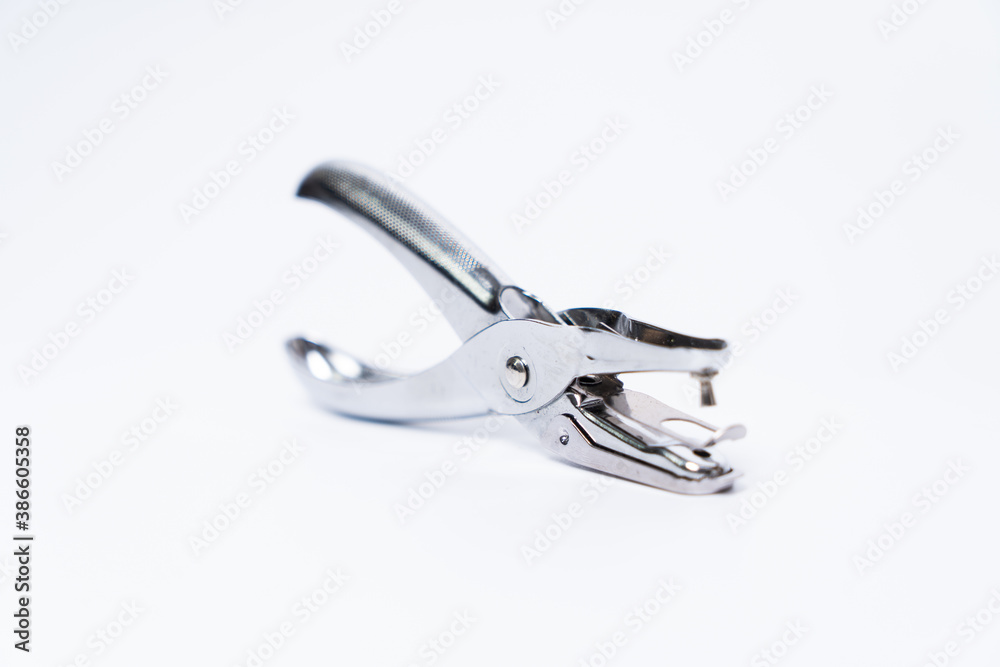 Metal Paper Hole Puncher Isolated on White Background. Metal Paper Hole Puncher Isolated on White Background.