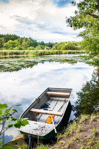 Fishermen boat on the shore of Konsky rybnik pond in Czech republic