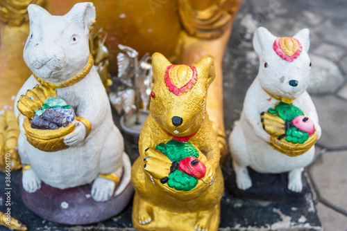 A gold stone statue of the rat.rat as the servants of Ganesha