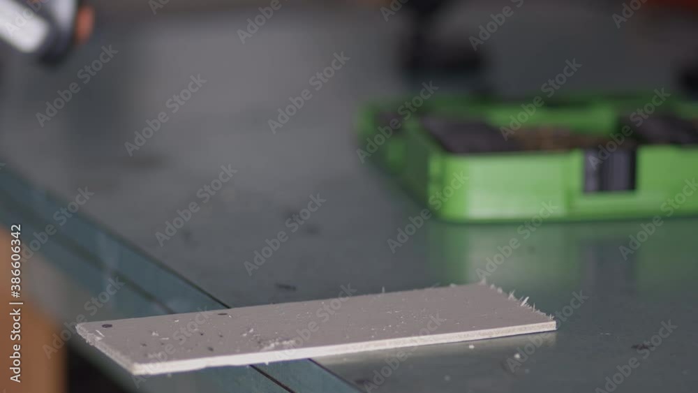 Man drills a piece of wood. Close up shot Man drills a piece of wood. Close up shot
