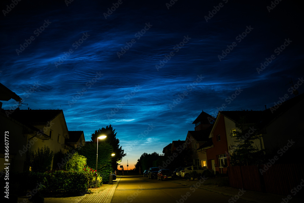 Nupaky, Czech republic - July 5, 2020. Noctilucent above street in small village near Prague Nupaky, Czech republic - July 5, 2020. Noctilucent above street in small village near Prague