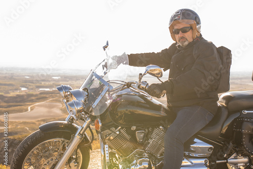 Fototapeta Naklejka Na Ścianę i Meble -  man with black road motorcycle