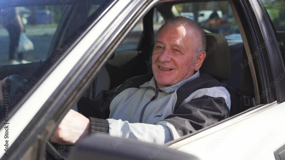 Caucasian elderly man using car, active happy retirement. Traveling alone on pension Caucasian elderly man using car, active happy retirement. Traveling alone on pension