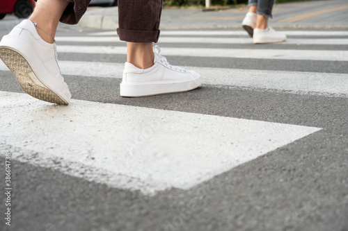 female feet crossing the crosswalk 