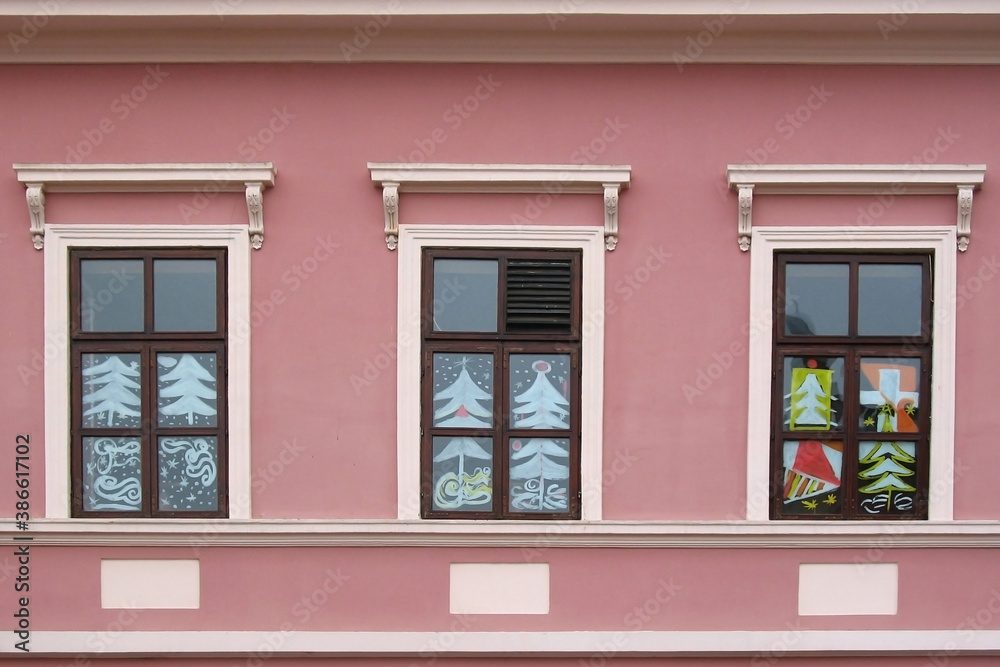 Three windows with Christmas painting decoration  on the pink wall
