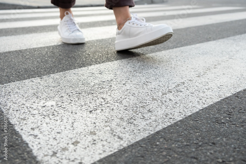female feet crossing the crosswalk