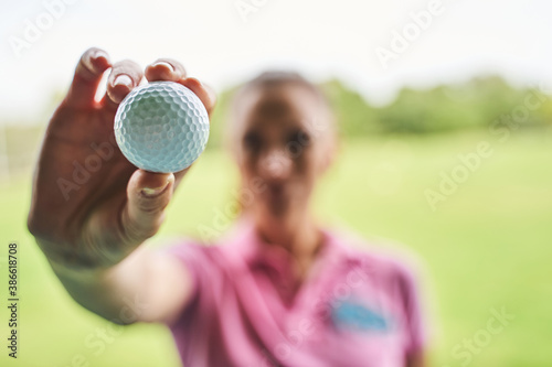 Fotografie Caucasian golfer in a polo shirt standing outdoors
