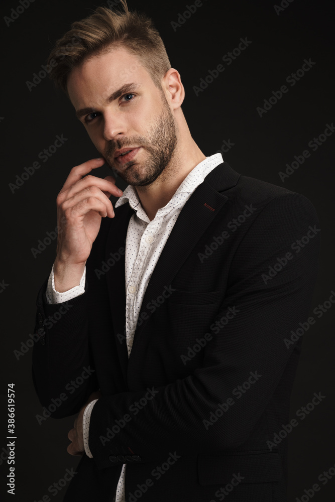 Handsome confident businessman posing and looking at camera Handsome confident businessman posing and looking at camera