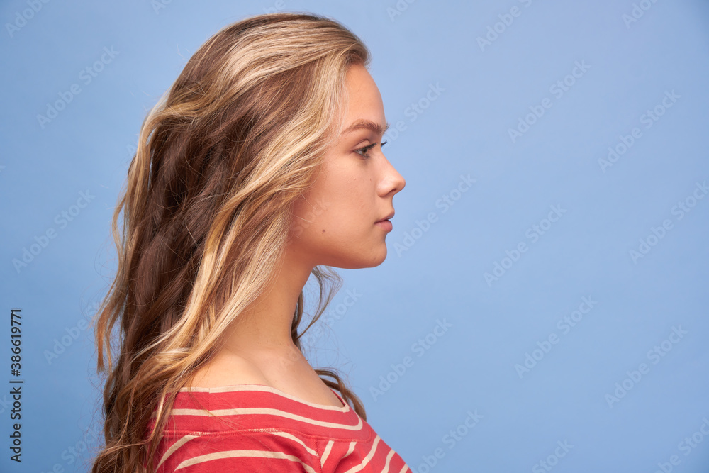 Close up profile side view portrait of her she is nice attractive lovely glitter pretty content serious calm girl cool modern hairstyle look trend decorative cosmetics blue background Close up profile side view portrait of her she is nice attractive lovely glitter pretty content serious calm girl cool modern hairstyle look trend decorative cosmetics blue background