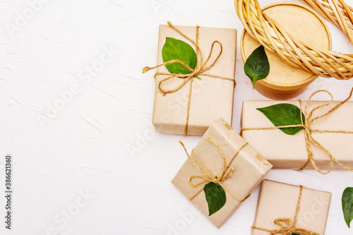 Zero waste gift concept with craft boxes and green leaves