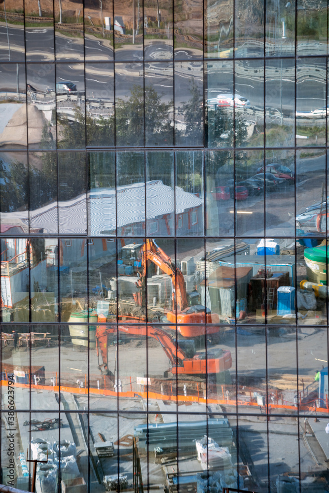 Reflection of the construction site in the glass facade