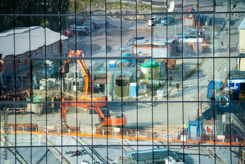 Reflection of the construction site in the glass facade