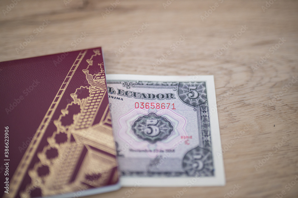 Five Ecuadorian Sucres Bill Partially Inside a Sweden Passport