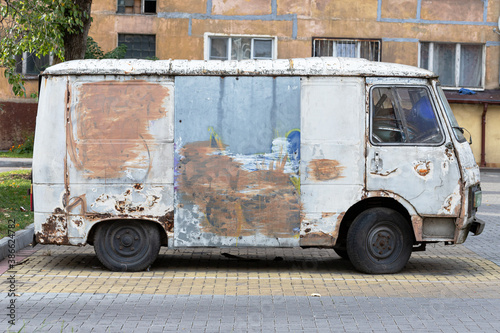 The old car is in a terrible state. Unsafe vehicle operation. Old, worn out, shabby, rotten, rusty car body. photo