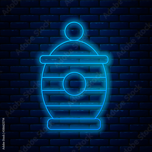 Glowing neon line Funeral urn icon isolated on brick wall background. Cremation and burial containers, columbarium vases, jars and pots with ashes. Vector.