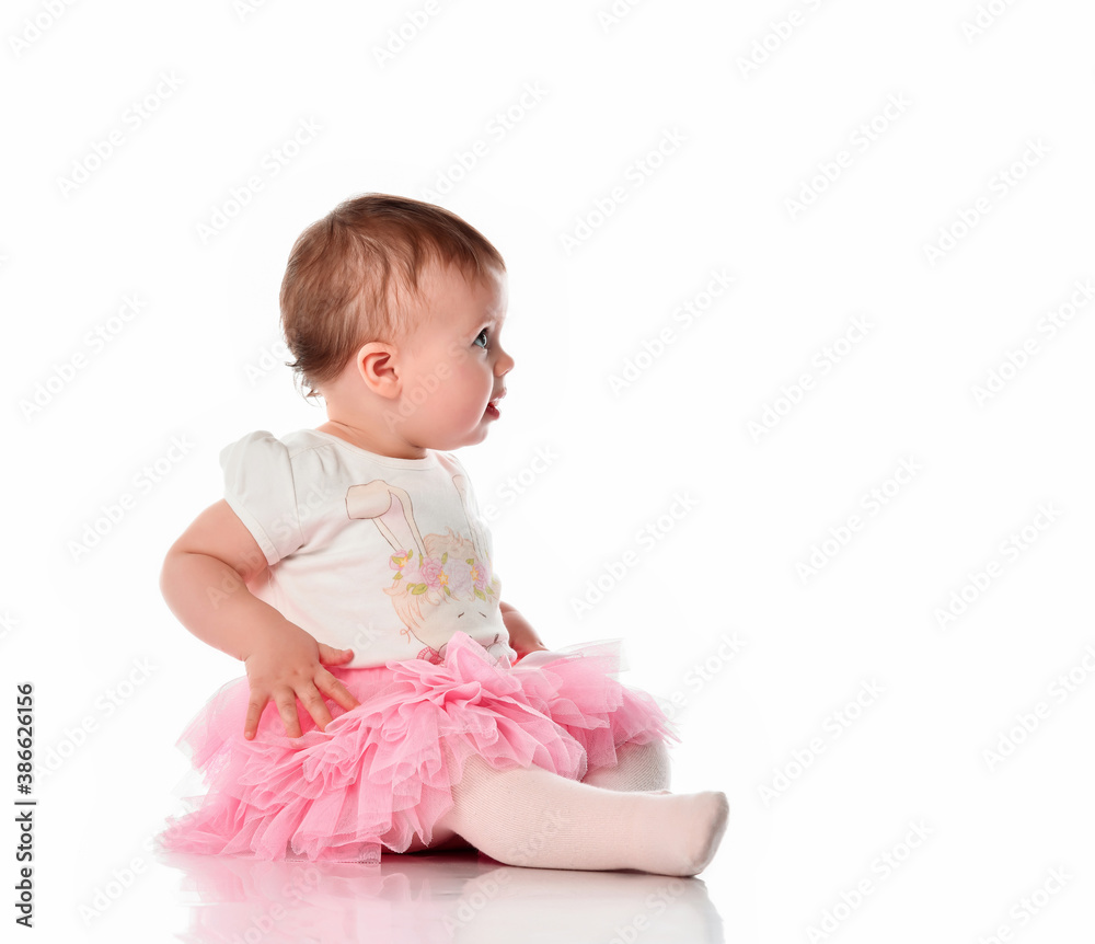 Surprised toddler child girl sitting on white floor Surprised toddler child girl sitting on white floor