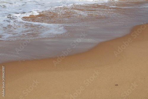 waves on the sand in a desert beach