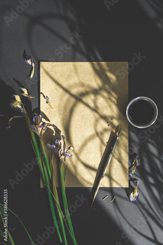 flowers, pen and craft paper on a black background