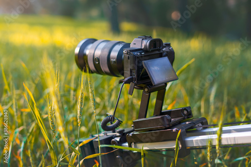 Video camera with professional filming equipment slider