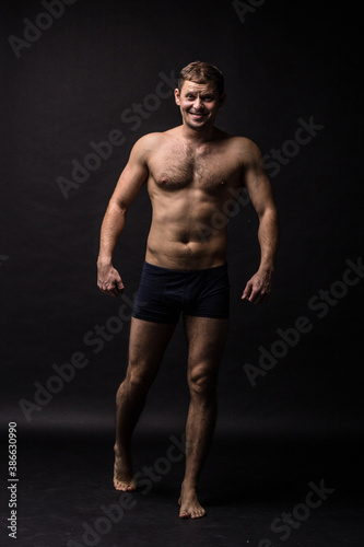 Handsome man in underwear on the black background. Muscular and athletic. Underwear man portrait. Male underwear model in studio 