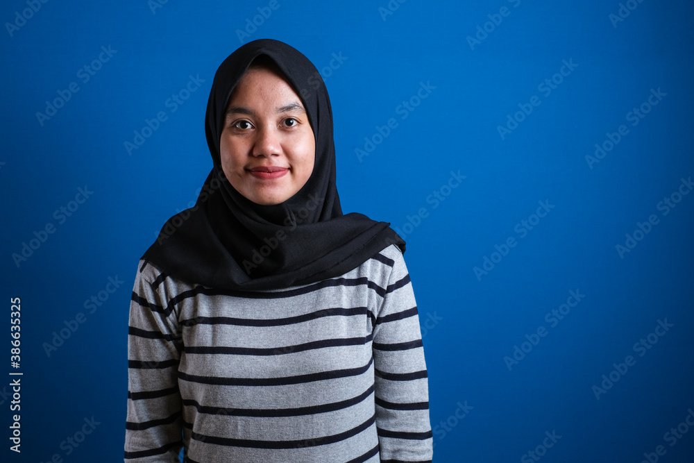 Muslim college student girl smiles to camera Muslim college student girl smiles to camera