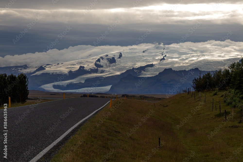 Road to Vatnajokull glacier, South Iceland.  Dramatic image of a mountain and a glacier on top.