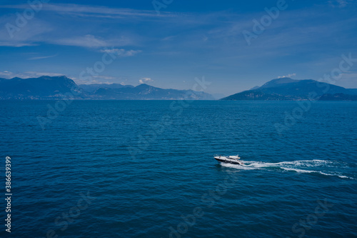 Top view of a white boat sailing in blue water. Motor boat in the lake. Travel - image