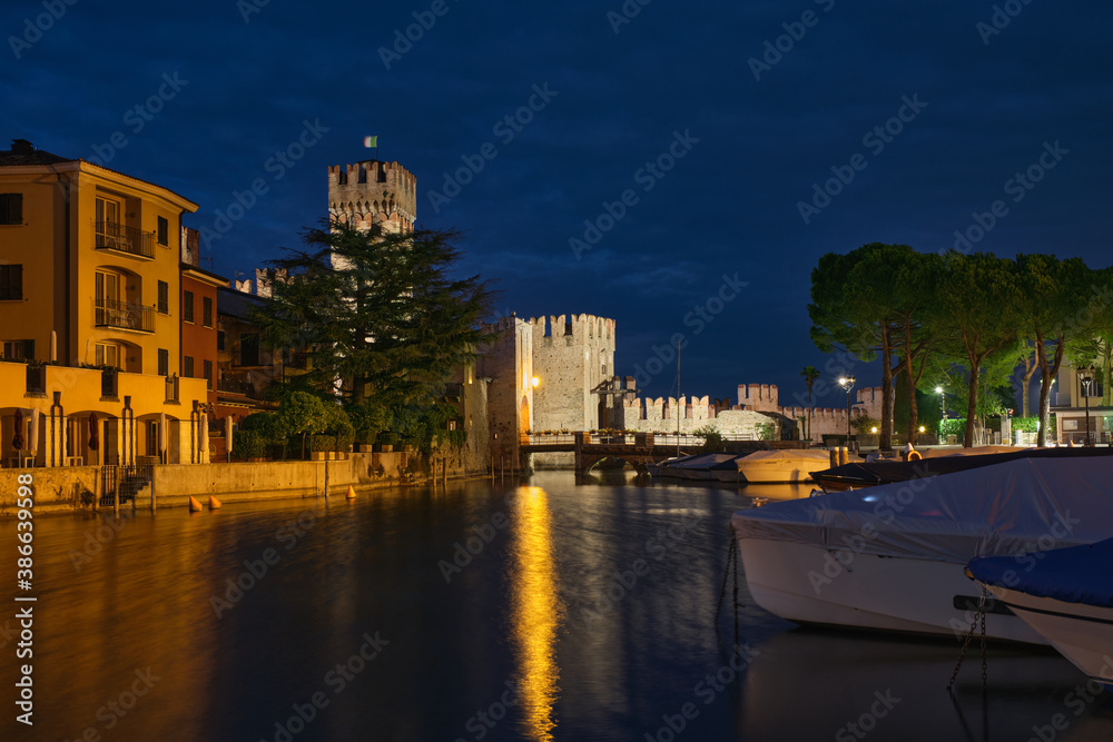 Historic castle in Italy on Lake Garda at night. Scaligero Castle Sirmione Italy.