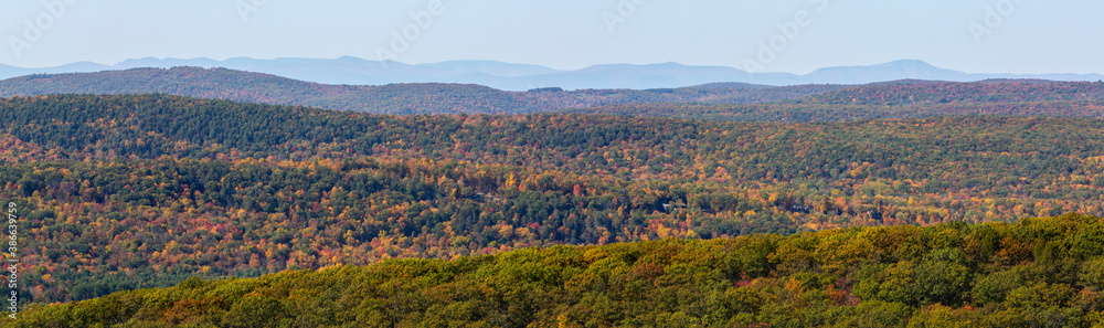 Panorama of colorful Autumn vistas of mountains and valleys. Yellow, orange and red leaves glisten in the sunshine- 10