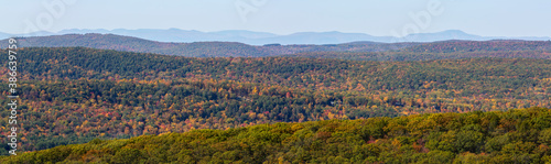 Panorama of colorful Autumn vistas of mountains and valleys. Yellow  orange and red leaves glisten in the sunshine- 10
