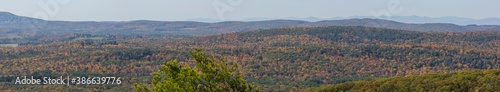 Panorama of colorful Autumn vistas of mountains and valleys. Yellow, orange and red leaves glisten in the sunshine- 9