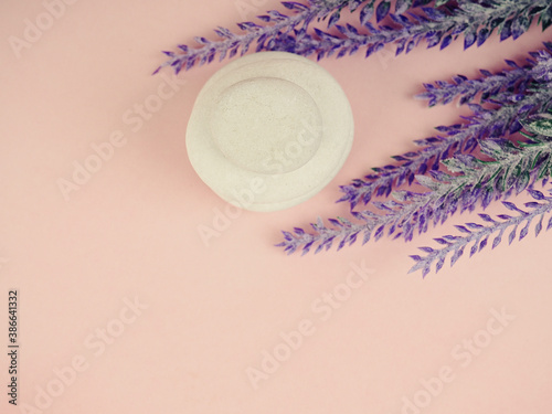 Zen stones and plants on a pink background, space for text. Zen spa stones with flowers. Rock, nature.