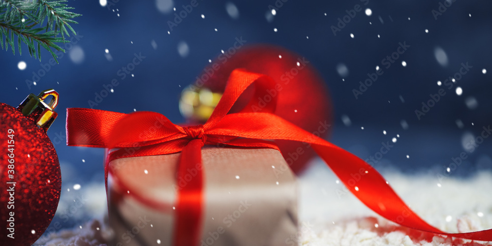 Close-up of Christmas gift box on artificial snow Close-up of Christmas gift box on artificial snow