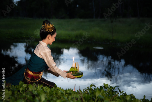 Loy Krathong Traditional Festival,Beautiful woman in thai dress traditional hold kratong. photo