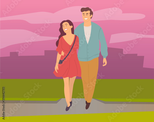 Dating couple outdoor cityscape in the evening time. Young peolpe smiling man and woman hugging walking. Girl with guy, people in love spend time together, relationships between male and female