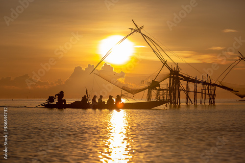 Tourists visit Chinese fish nets during sunrise in Phatthalung province, Thailand