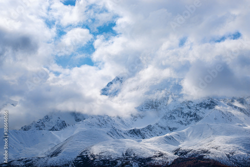 panoramic view of picturesque snowy mountains tops on blue sky background © photollurg