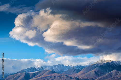 panoramic view of picturesque snowy mountains tops on blue sky background