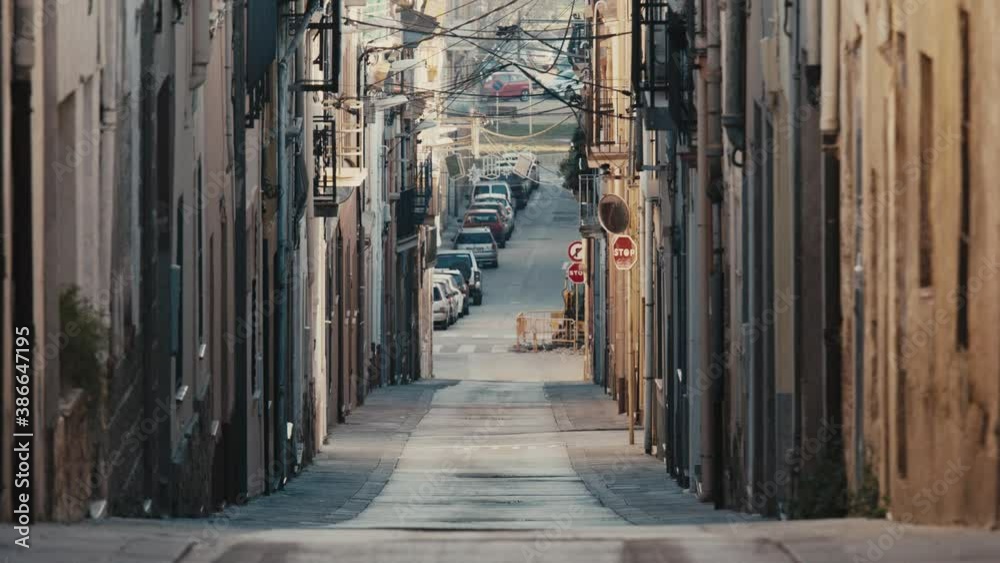 Empty alleyway in Europe during the day time due to COVID-19 quarantine until one person walks past Empty alleyway in Europe during the day time due to COVID-19 quarantine until one person walks past