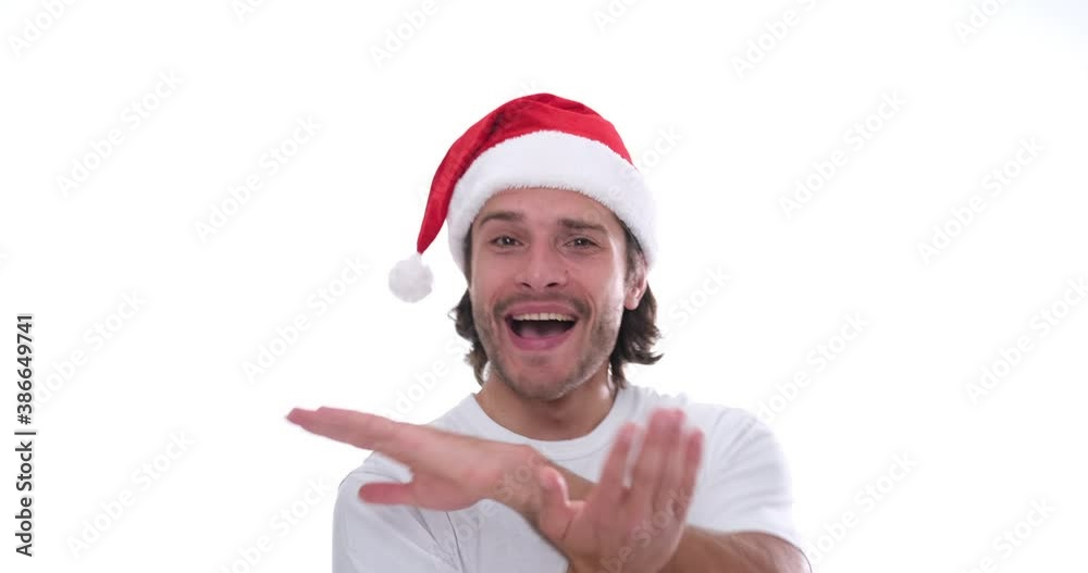 Carefree man in santa hat dancing over white background Carefree man in santa hat dancing over white background