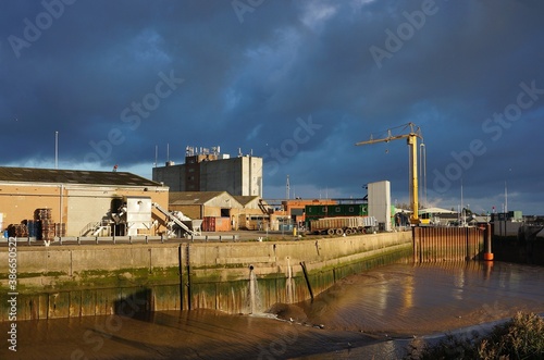 Industrial docks by the river with dark cloudy background. Boston Lincolnshire